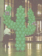 An 8-foot cactus made of green balloons just inside the main door to the Exhibit Hall